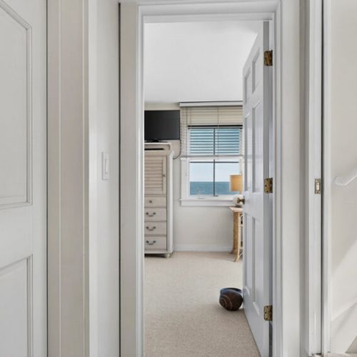 Hallway leading to primary bedroom