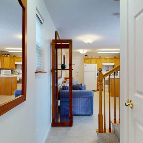 Hallway from first floor bathroom to open concept living and dining