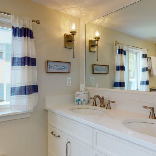 Additional bathroom on first floor | full bathroom off of kitchen| double sinks| shower/tub combo