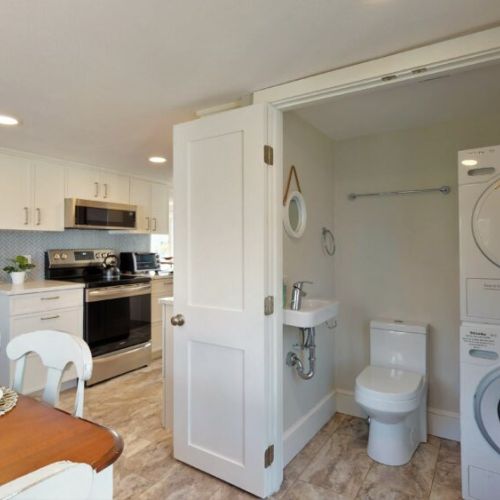 1/2 bath attached to kitchen with stack pack washer and dryer