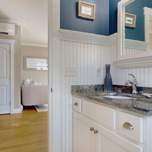 Second floor half bath located off the kitchen next to the stairs