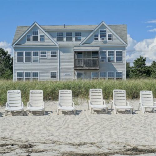 View of property from beach | beach area with designated lounge chairs | 7 miles of sandy beach